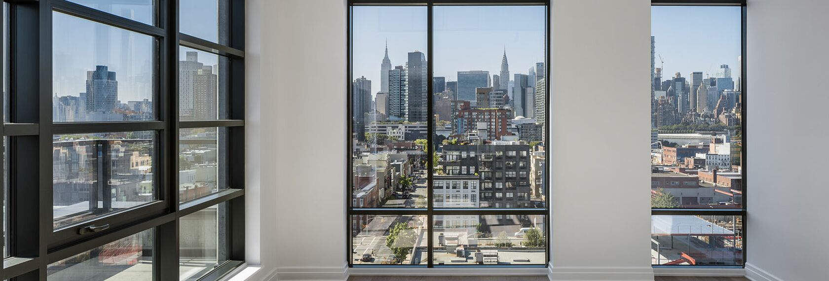 Interior view of New York penthouse, featuring floor-to-ceiling windows.